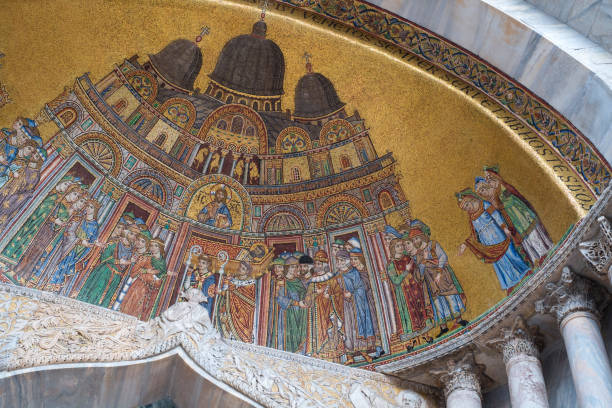 A 13th century mosaic (Processional Transfer of St Mark to the Basilica) on the exterior of the historical St Mark's Basilica in Venice, Italy.