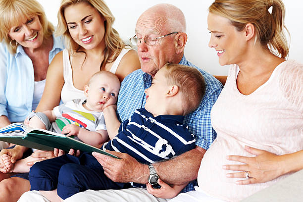 Happy and smiling three generation family sharing a book together