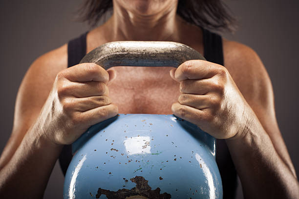 Blue Kettle Bell Held by Athletic Woman stock photo