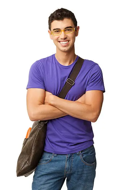 Portrait of happy young male student in casual wear with shoulder bag standing arms crossed. Vertical shot. Isolated on white.