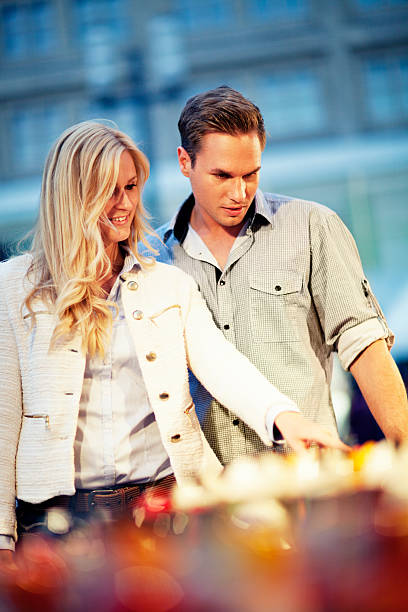 istock Man And Woman Looking At Stand 171372537
