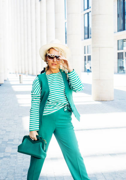 Smiling Woman Outdoor Portrait. Fashion trend of summer or spring. Young blond woman wearing hat and sunglasses. Fashion trend of summer or spring. Lifestyle concept, older woman purse stock pictures, royalty-free photos & images