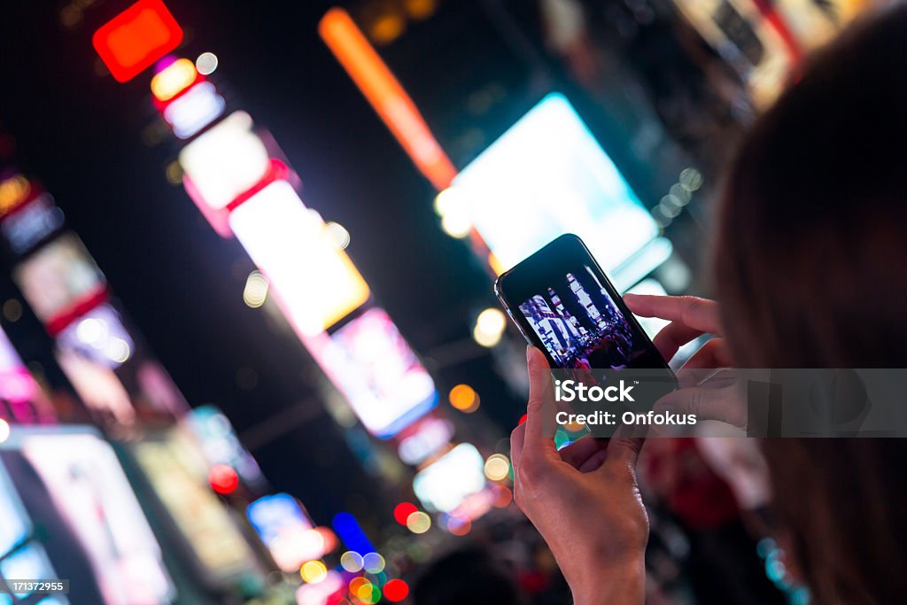 Woman Taking Picture With Smartphone at Times Squares, New York Filming Stock Photo