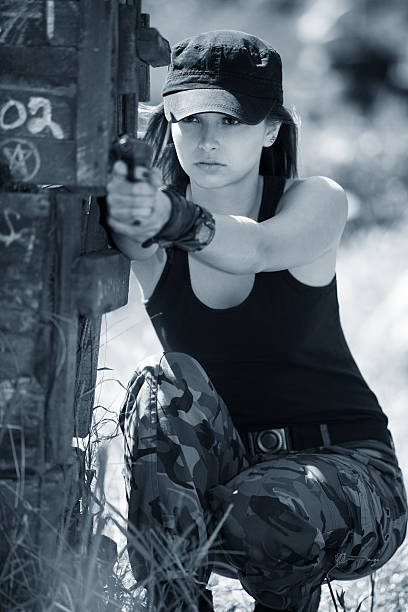 istock beautiful woman with gun 171373514