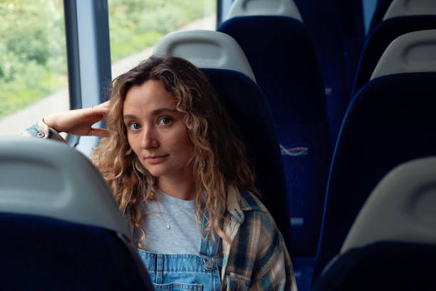istock Woman on train looking at camera 1713735296