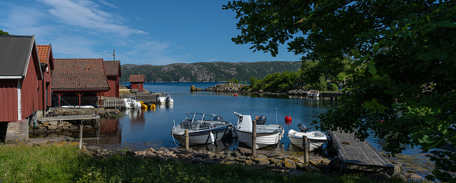 Lyngdal, Norway - July 06 2023: Boat houses and boats at Lundegaard.