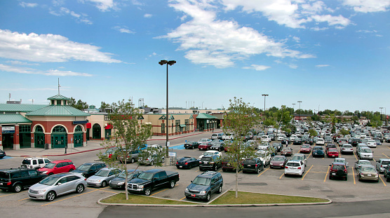 Parking  lot at a shopping center showing strong consumerism and retail sales