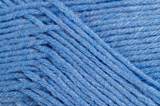 woolen threads of blue color for knitting, thin blue threads for knitting close-up