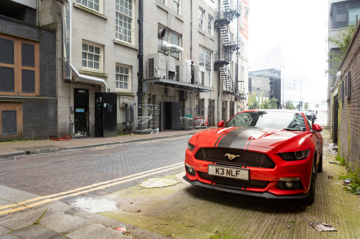 Liverpool, united kingdom May, 16, 2023  view of red Ford Mustang GT 5.0 parked in a urban back street