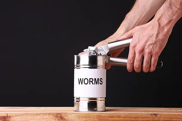 Unrecognizable person opening a can of worms.  Creating a situation that will cause problems.Some other related images: