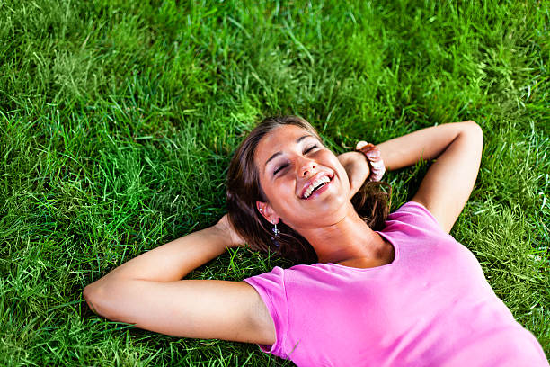 istock Woman daydreaming on green grass, copy space 171375155