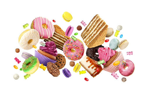 Many delicious sweets falling on white background