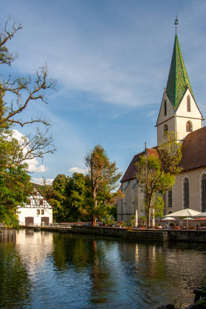 istock Monastery church in Blaubeuren is reflected in the Blautopf 1713755860