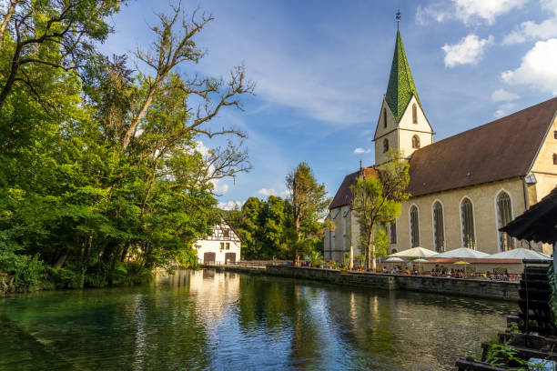 istock Monastery church in Blaubeuren is reflected in the Blautopf 1713755864