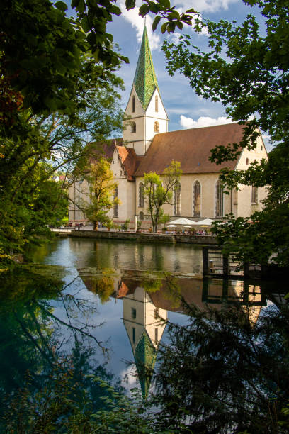 istock Monastery church in Blaubeuren is reflected in the Blautopf 1713756398