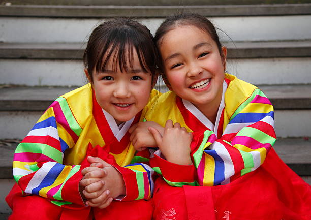 Happy Hanbok - two young girls in colorful dresses smiling stock photo