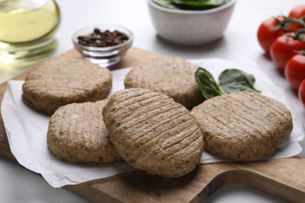 istock Raw vegan cutlets and different products on white table, closeup 1713761214