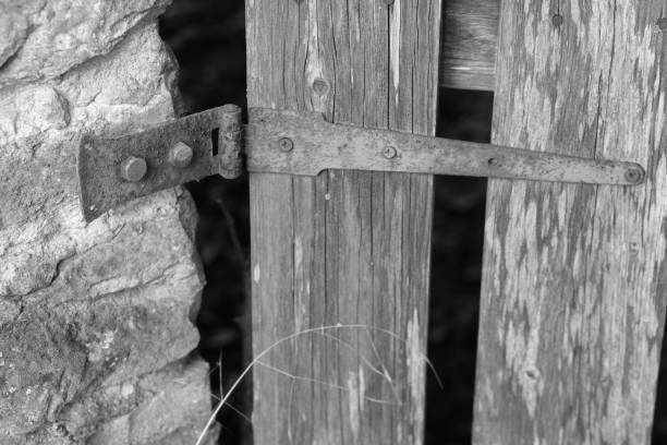 istock Rusty Hinge between Stone and Wood in Black and White 1713764118