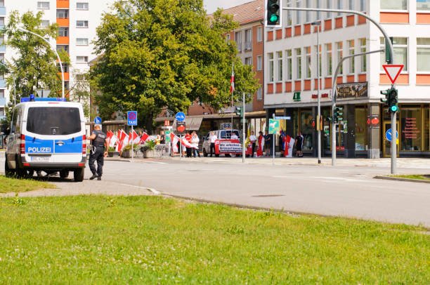 Demonstration NPD "Eisenhuettenstadt, Germany - August 04, 2012: Demonstration of the National Democratic Party of Germany (NPD) in Eisenhuettenstadt, Germany. NPD activists demonstrate against the European Union and the EURO. The National Democratic Party of Germany (NPD) is a small German party, founded in 1964. Units of riot police watch and secure the demonstration." national democratic party of germany stock pictures, royalty-free photos & images