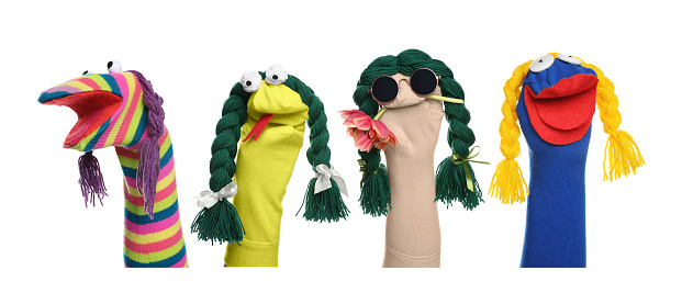 Many colorful sock puppets with braids on white background, collage design