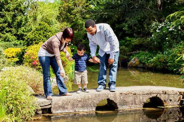 istock Family Watching Coy Fish at The Park 171376906
