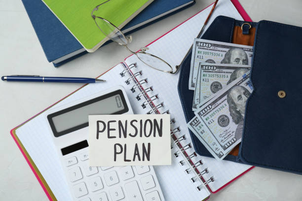 istock Card with phrase Pension Plan, dollar banknotes, calculator and notebooks on white office table, flat lay 1713769397