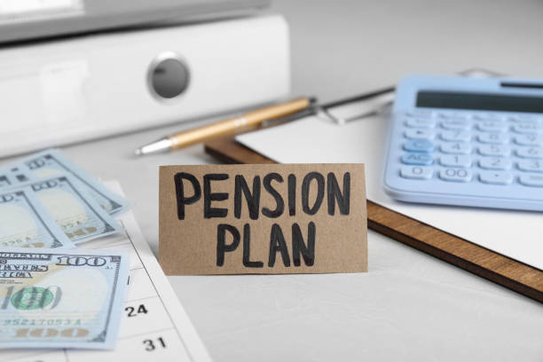 istock Card with phrase Pension Plan, calculator, dollar banknotes and calendar on white office table, closeup 1713769419