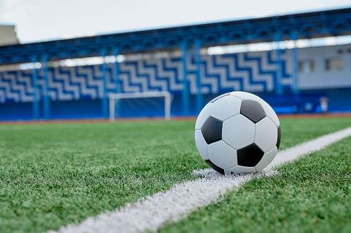 Soccer ball in the corner of football field