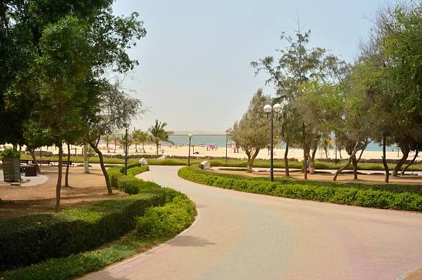 Families enjoy the warm waters of the Gulf of Oman at the Mamzar Park Beach in Dubai at the end of this serpentine walkway.