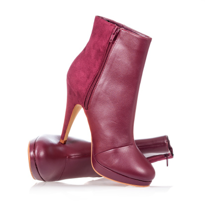 Ankle boots in ruby-red, model for fall/winter season 2013, isolated on white, lots of copy space.