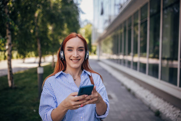 istock Redhead woman listening music 1713774952