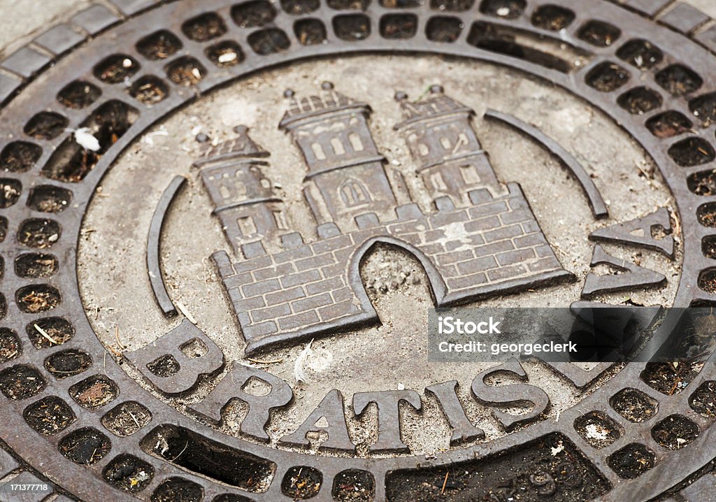 Bratislava Historical Manhole Cover The historic castle coat of arms of the Slovakian city of Bratislava on a traditional manhole cover. Bratislava Stock Photo