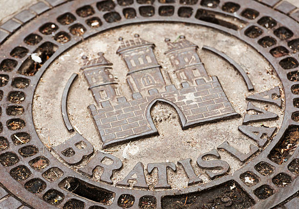 Bratislava Historical Manhole Cover The historic castle coat of arms of the Slovakian city of Bratislava on a traditional manhole cover. bratislava castle bratislava castle fort stock pictures, royalty-free photos & images
