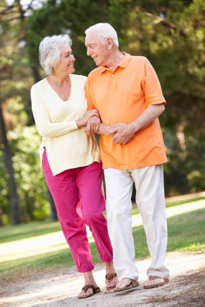 istock Senior Couple Walking In Park Together 171377748