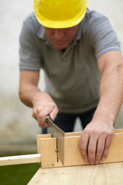istock Carpenter sawing a wooden beam 171377950