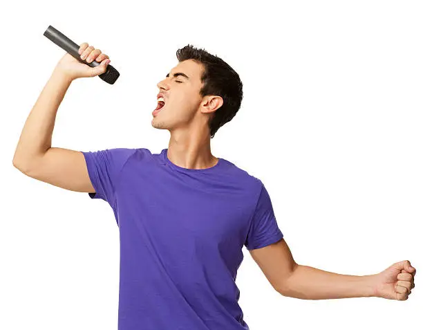Young boy singing his heart out into a microphone. Horizontal shot. Isolated on white.