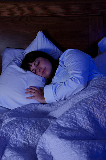 Woman Sleeping Alone At Night stock photo