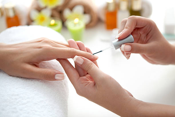 Manicure. Close up of beautiful female hands having manicure treatment. Nail polishing. apocynaceae stock pictures, royalty-free photos & images