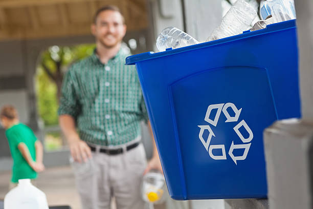 istock Volunteer recycling plastic bottle - close up on recycle bin 171378611