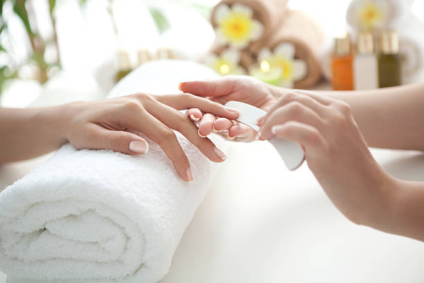 Manicure. Close up of beautiful female hands having manicure treatment. See more MANICURE and SPA images. Click on image below for lightbox. nail salon stock pictures, royalty-free photos & images