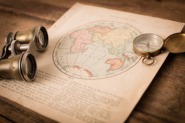 Antique 1870 Map of Eastern Hemisphere, Binoculars, and Compass "Color image of an old map of the Eastern Hemisphere, from the 1800's, with binoculars and a compass, on wood background.  Map is from an old geography book with an 1870 copyright." eastern hemisphere stock pictures, royalty-free photos & images