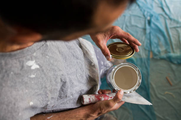 istock Painter Opening The Lid Of A Paint Can 1713795756