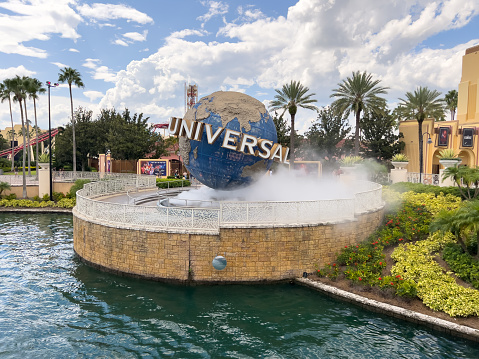 Orlando, FL, USA - September 10, 2023: Universal Studios Florida is a family theme park with entertainment theme rides and attractions. The Universal globe is located at the entrance of the park for guests to see before entering and open to the public.