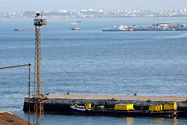 istock Concrete jetty and barges on Tagus River in Lisbon 171381037