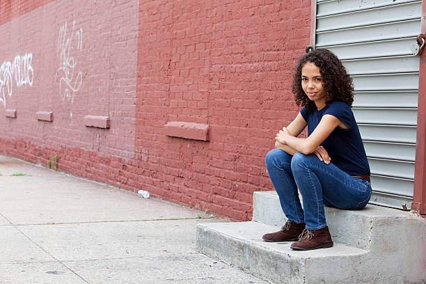 istock Smiling girl sitting on steps 171381067
