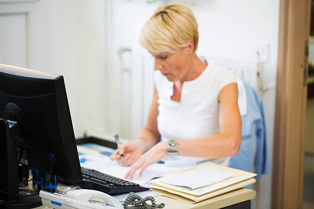 istock Nurse in her office,her daily paper work... 171381134