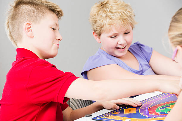 istock Group of kids playing a board game 171381206