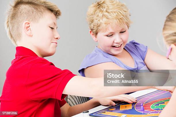 Group Of Kids Playing A Board Game Stock Photo - Download Image Now - 10-11 Years, Activity, Adolescence