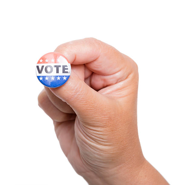 istock Human hand hlding a Vote badge isolated on white 171381380