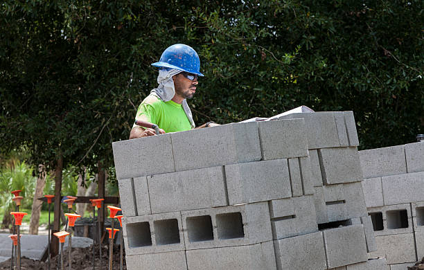 istock Hispanic Construction Supervisor Reviews Plan on Job Site 171381528